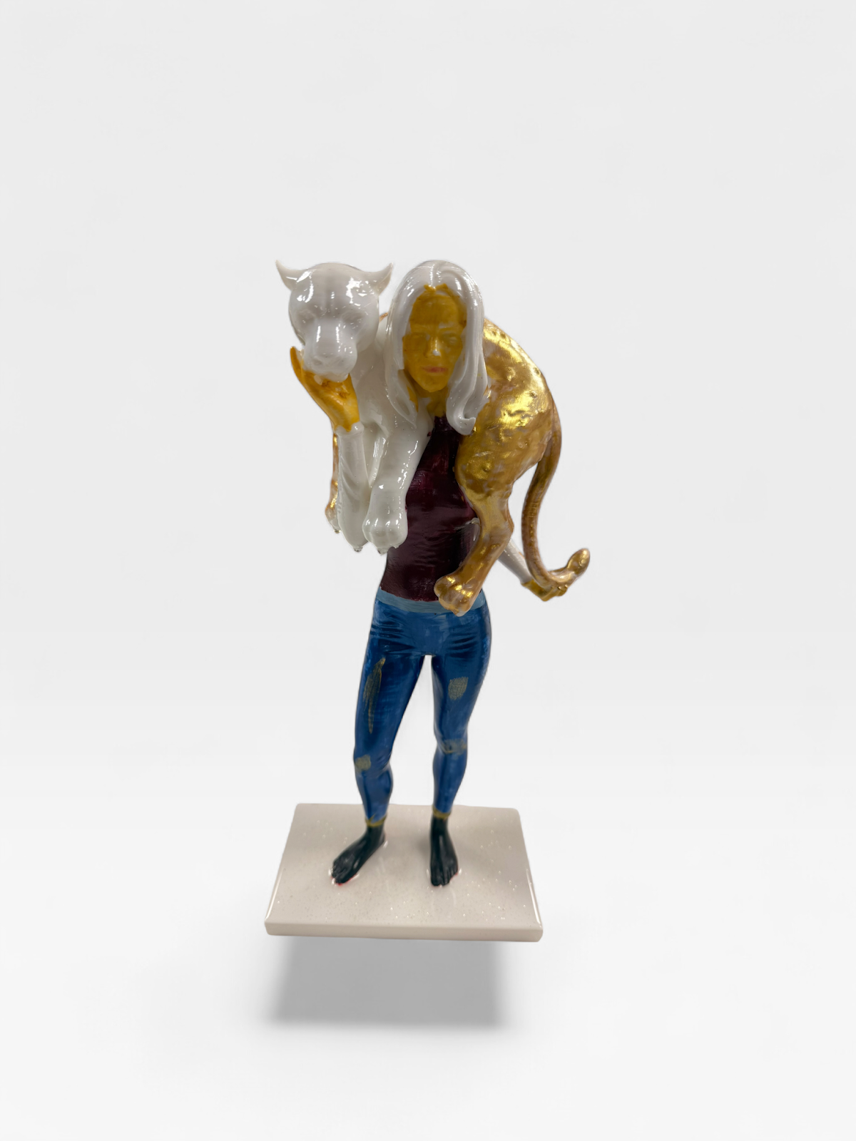 Woman carrying gold and white panther sculpture, JebaraArt